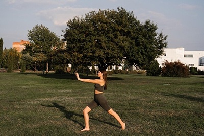 Asian Girl Does tai chi On Green Grass