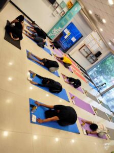 employees doing yoga at office