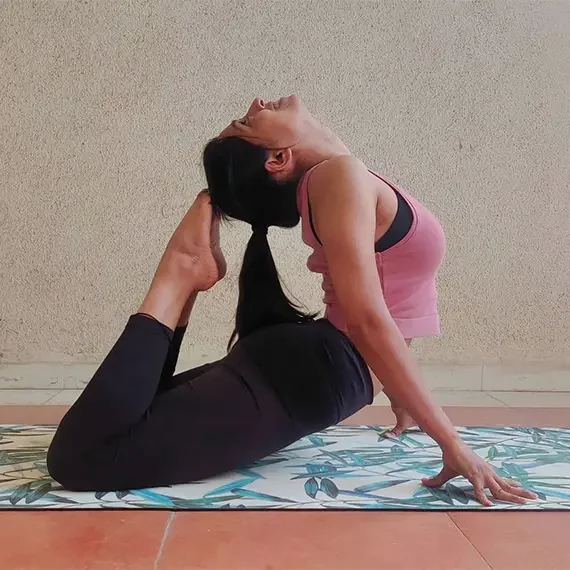 Flexible Female Indian Yoga Trainer in Goa Performing Bhujangasana